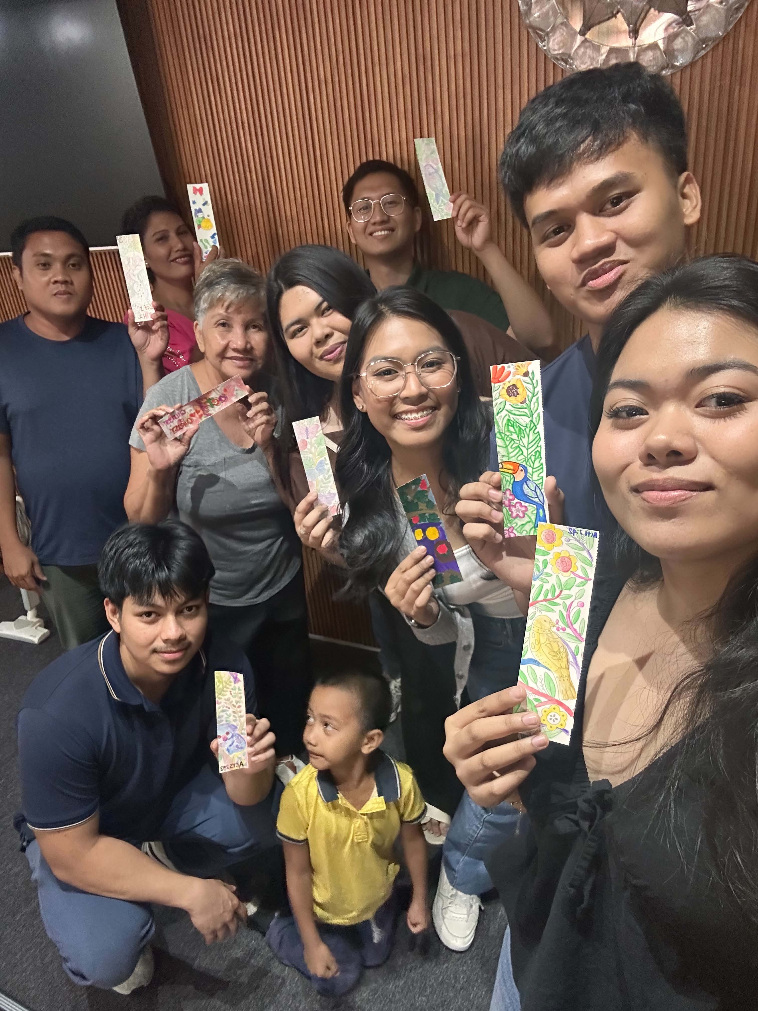 Full group showing their finished bookmarks — kids, teens, young adults